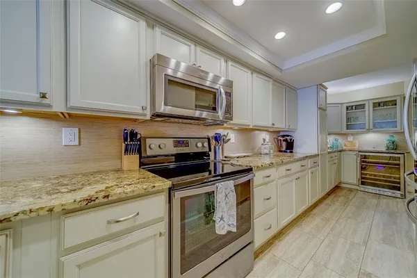 a kitchen with refrigerator and cabinets