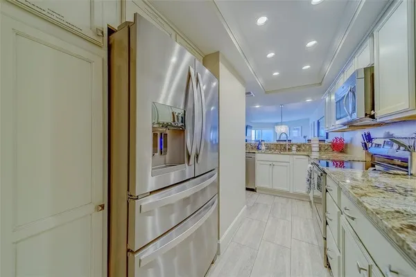 a kitchen with stainless steel appliances granite countertop a sink and cabinets