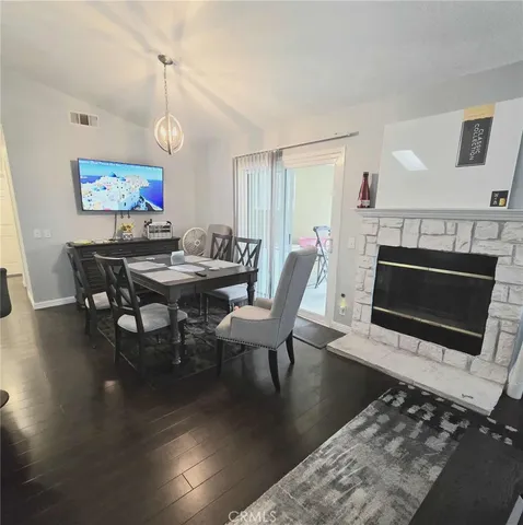 a living room with lots of furniture and view of kitchen