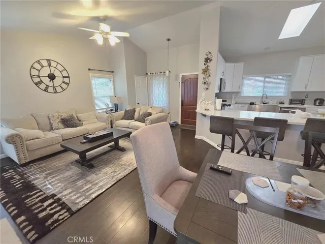 a living room with furniture a rug and a window