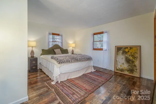 a living room with a bed and painting on the wall