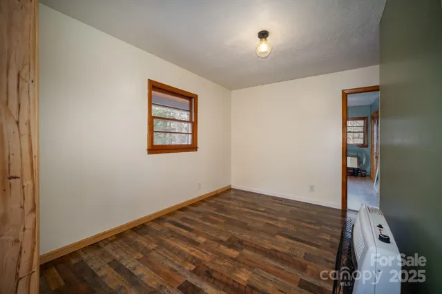 a view of a room with wooden floor and closet