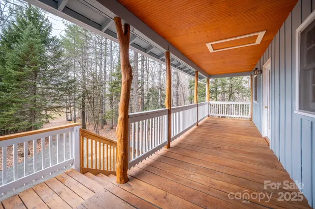 a view of a porch with wooden floor of a house
