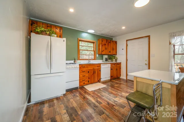 a kitchen with a refrigerator and a stove top oven