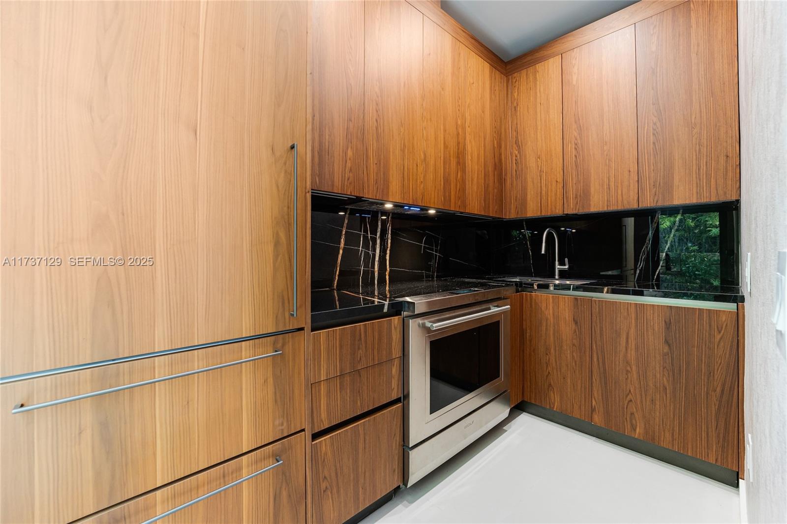 1785 Cleveland Road Miami Beach, FL 33141 - Photo 24 of 67 a kitchen with granite countertop a stove and a sink