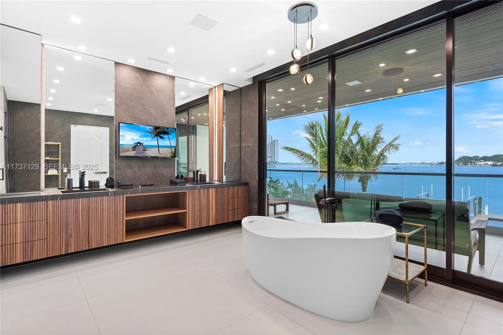 1785 Cleveland Road Miami Beach, FL 33141 - Photo 28 of 67 a large white kitchen with a large window and stainless steel appliances