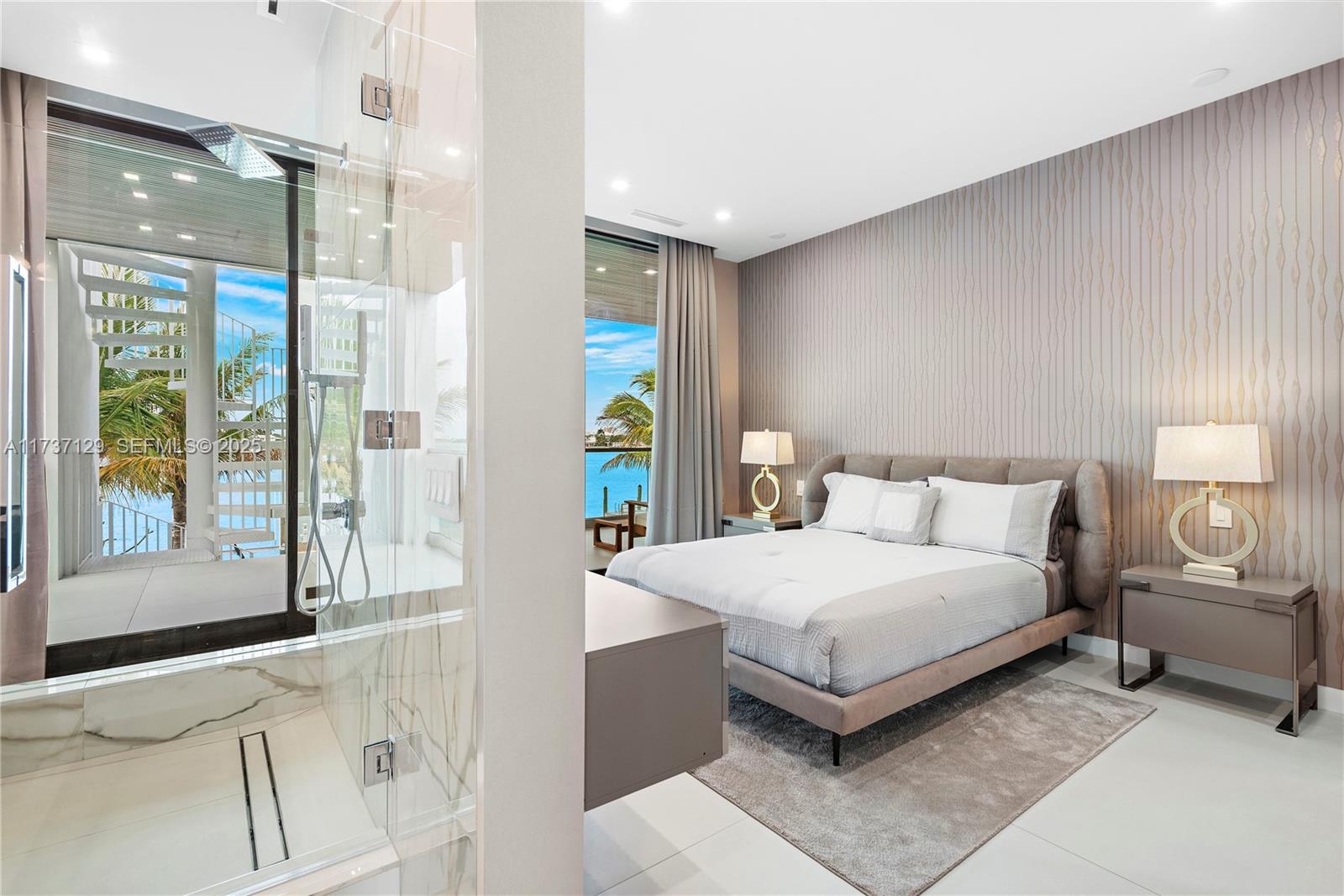 1785 Cleveland Road Miami Beach, FL 33141 - Photo 32 of 67 a bedroom with a bed lamp and a large window with outer view