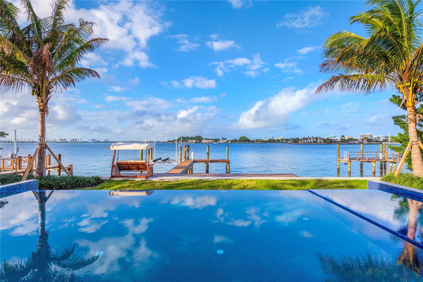 1785 Cleveland Road Miami Beach, FL 33141 - Photo 44 of 67 a view of a swimming pool with a table and chairs under an umbrella