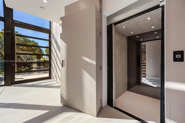 a view of a hallway with windows and entryway