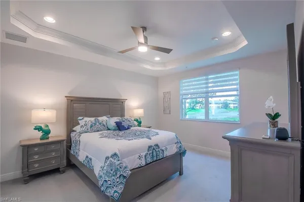 a bedroom with a bed and a potted plant