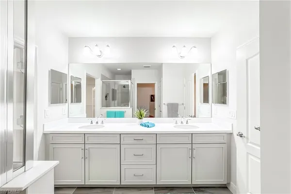 a bathroom with a double vanity sink mirror and double