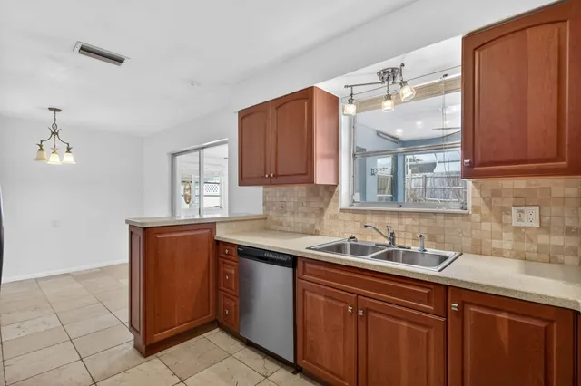 a kitchen with stainless steel appliances granite countertop a sink and cabinets