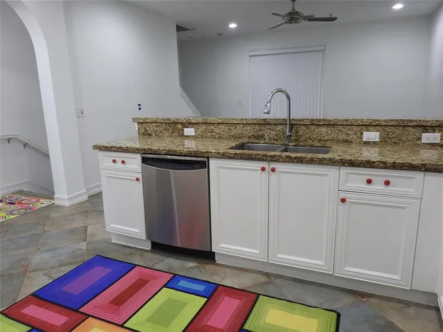 a kitchen with sink and cabinets