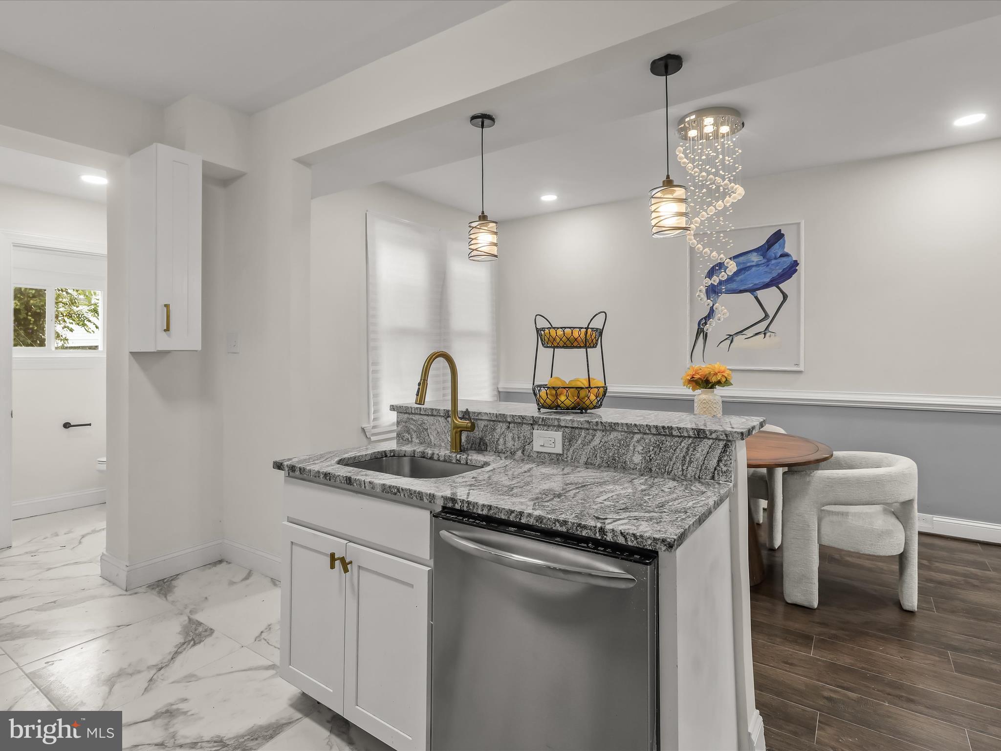 732 Edgewood Street Baltimore, MD 21229 - Photo 13 of 41 a kitchen with a sink cabinets and wooden floor