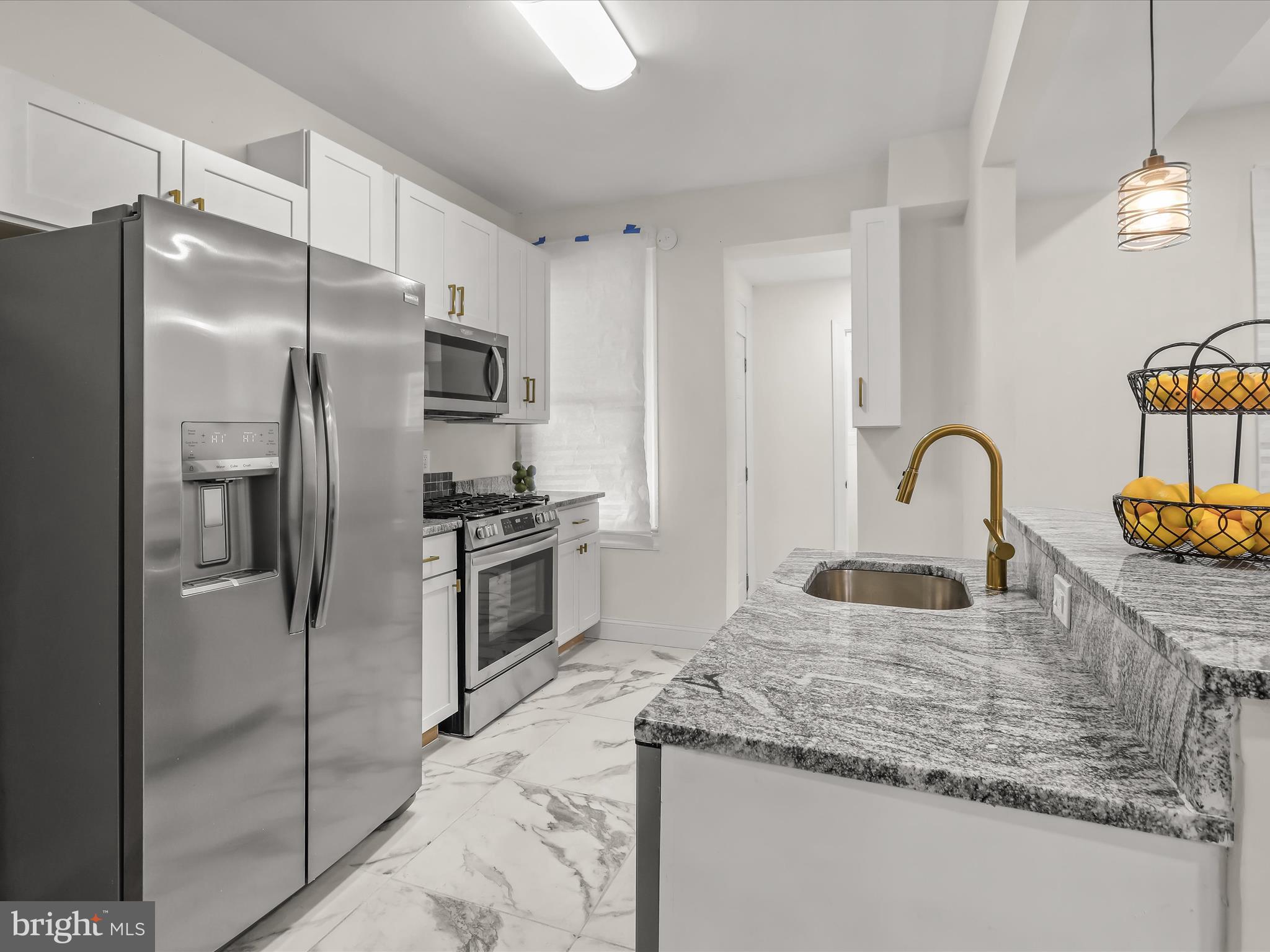 732 Edgewood Street Baltimore, MD 21229 - Photo 15 of 41 a kitchen with stainless steel appliances granite countertop a refrigerator and a sink