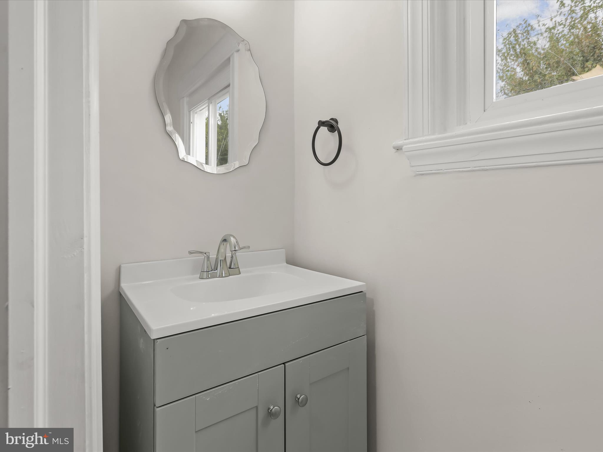 732 Edgewood Street Baltimore, MD 21229 - Photo 17 of 41 a bathroom with a sink and a mirror