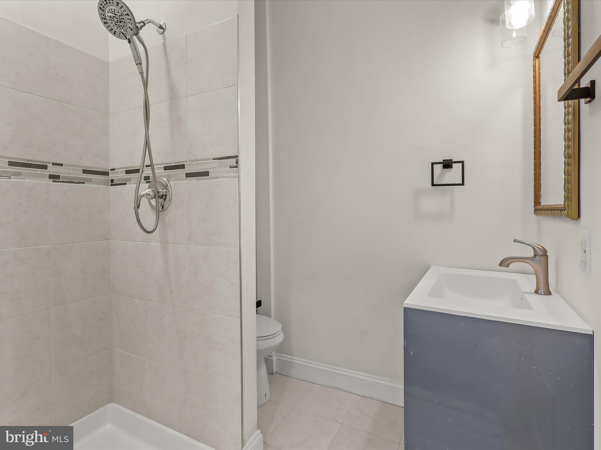 732 Edgewood Street Baltimore, MD 21229 - Photo 23 of 41 a bathroom with a shower and a sink