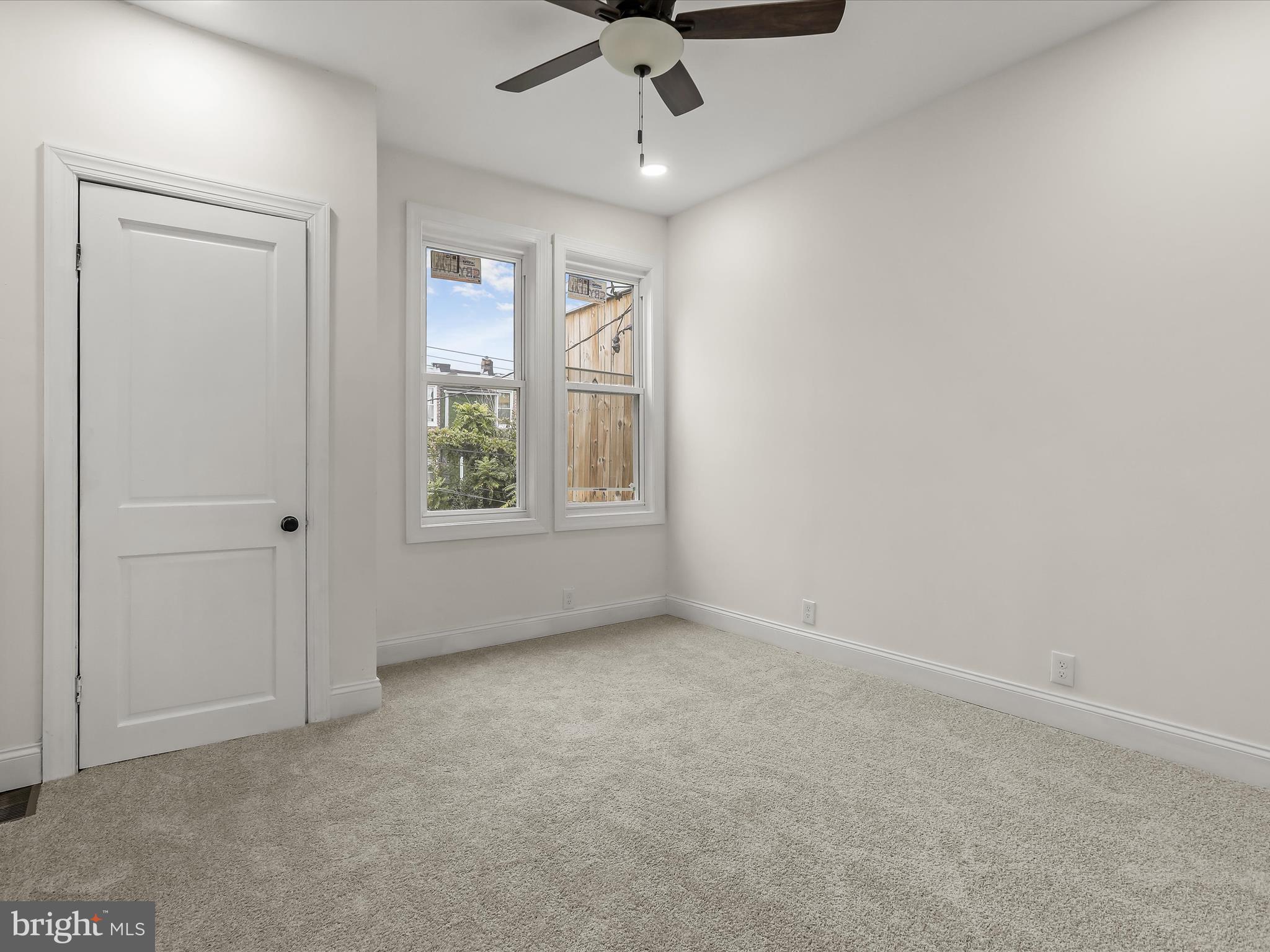 732 Edgewood Street Baltimore, MD 21229 - Photo 27 of 41 en empty room with windows and ceiling fan