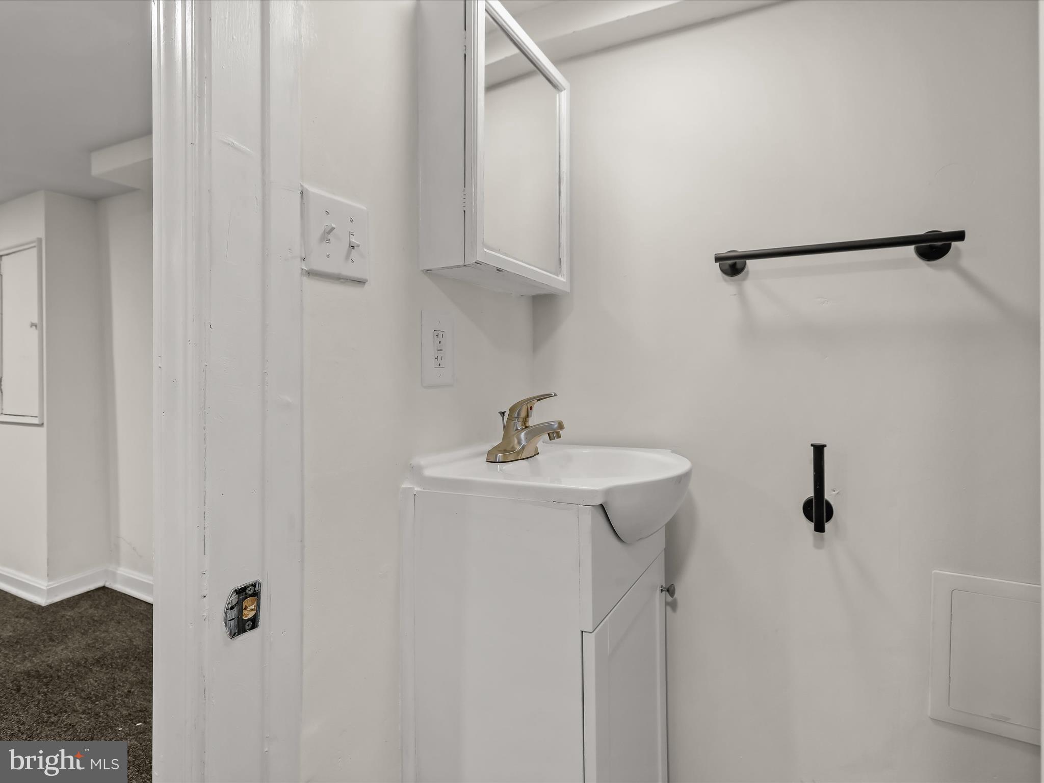 732 Edgewood Street Baltimore, MD 21229 - Photo 33 of 41 a bathroom with a sink and mirror