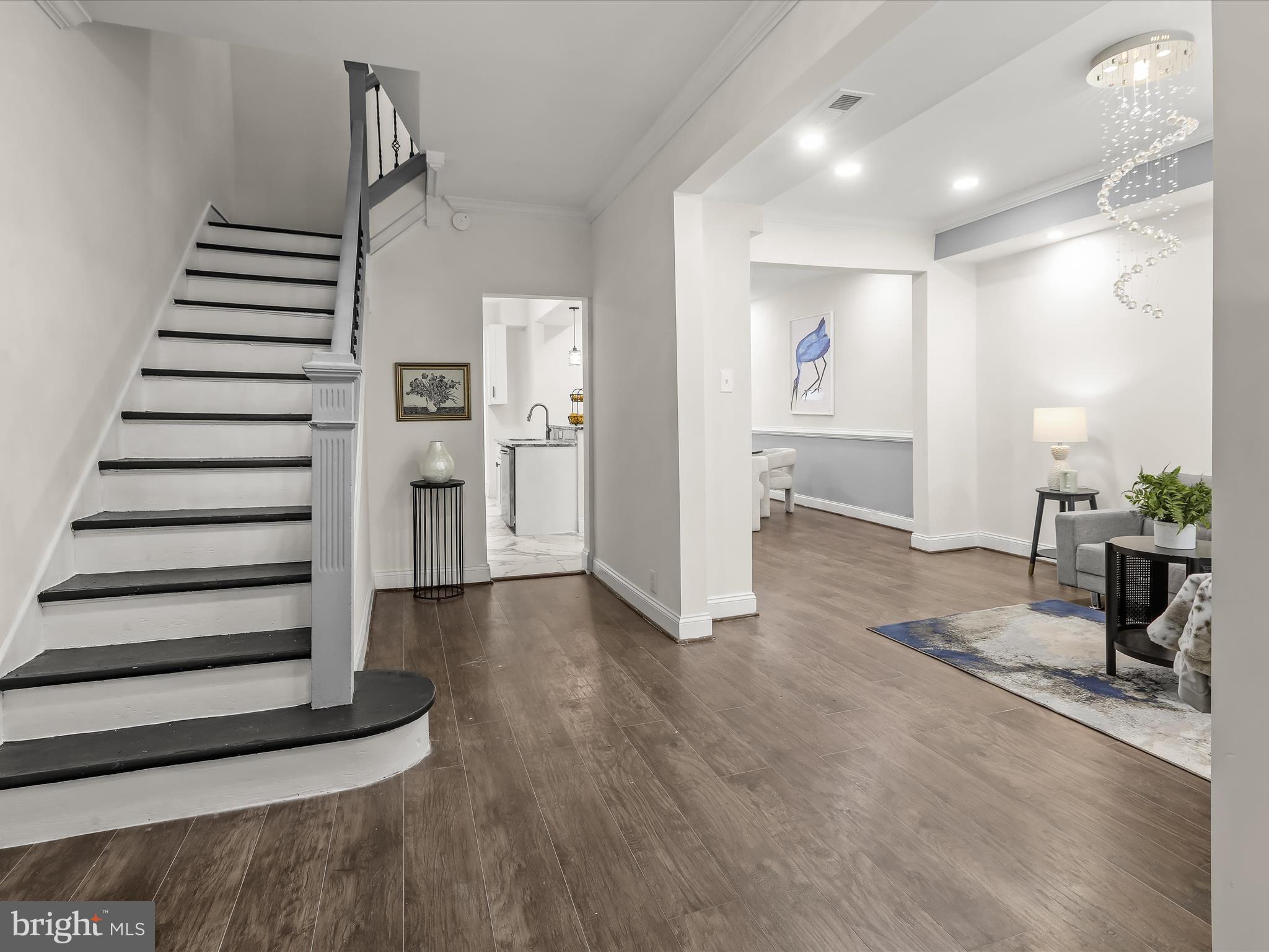 732 Edgewood Street Baltimore, MD 21229 - Photo 4 of 41 a view of a hallway with wooden floor and staircase
