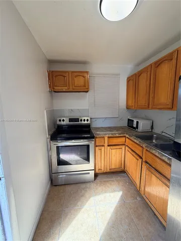 a kitchen with a sink stove and microwave