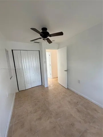 a view of an empty room and a window