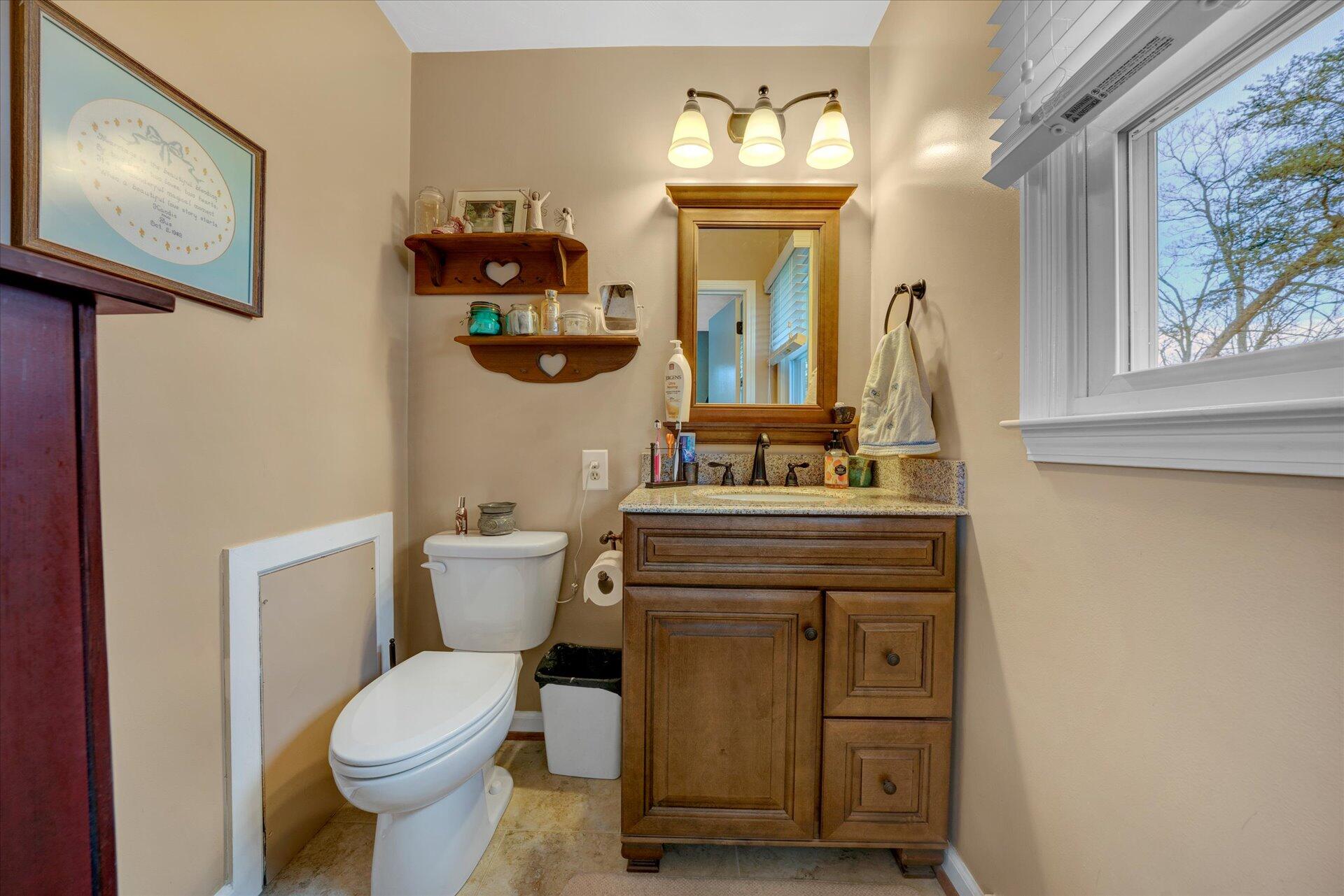 111 Deep Dell Road Salem, VA 24153 - Photo 14 of 39 a bathroom with a toilet sink and mirror