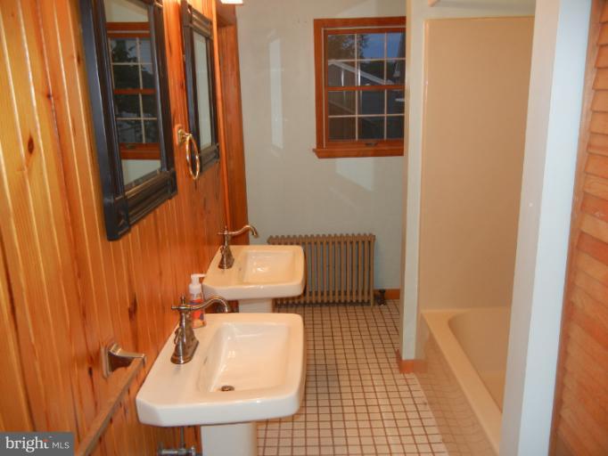 111 Homewood Road Linthicum Heights, MD 21090 - Photo 4 of 14 a bathroom with a sink and mirror