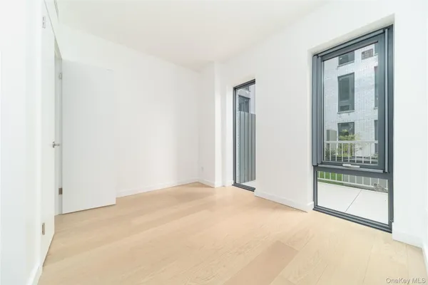 a view of an empty room with glass door