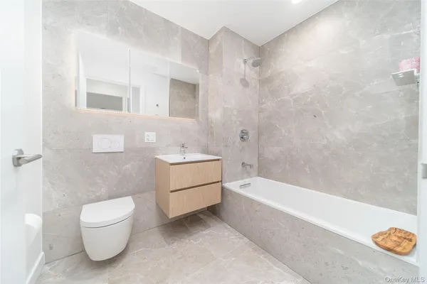 a bathroom with a toilet a sink and bathtub