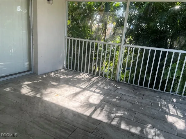 a view of a lake with a yard and large trees