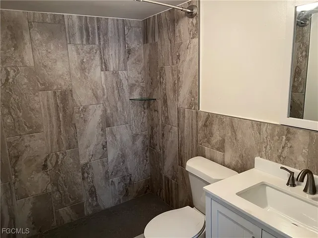 a bathroom with a toilet sink and shower