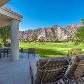 a view of a chairs and table in patio with a lake view
