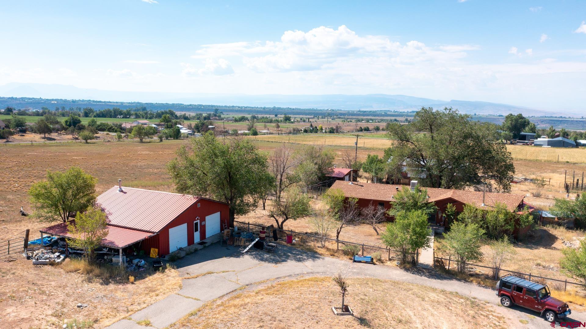 25186 Cedar Mesa Road Cedaredge, CO 81413 - Photo 4 of 17 an aerial view of a house with a lake view