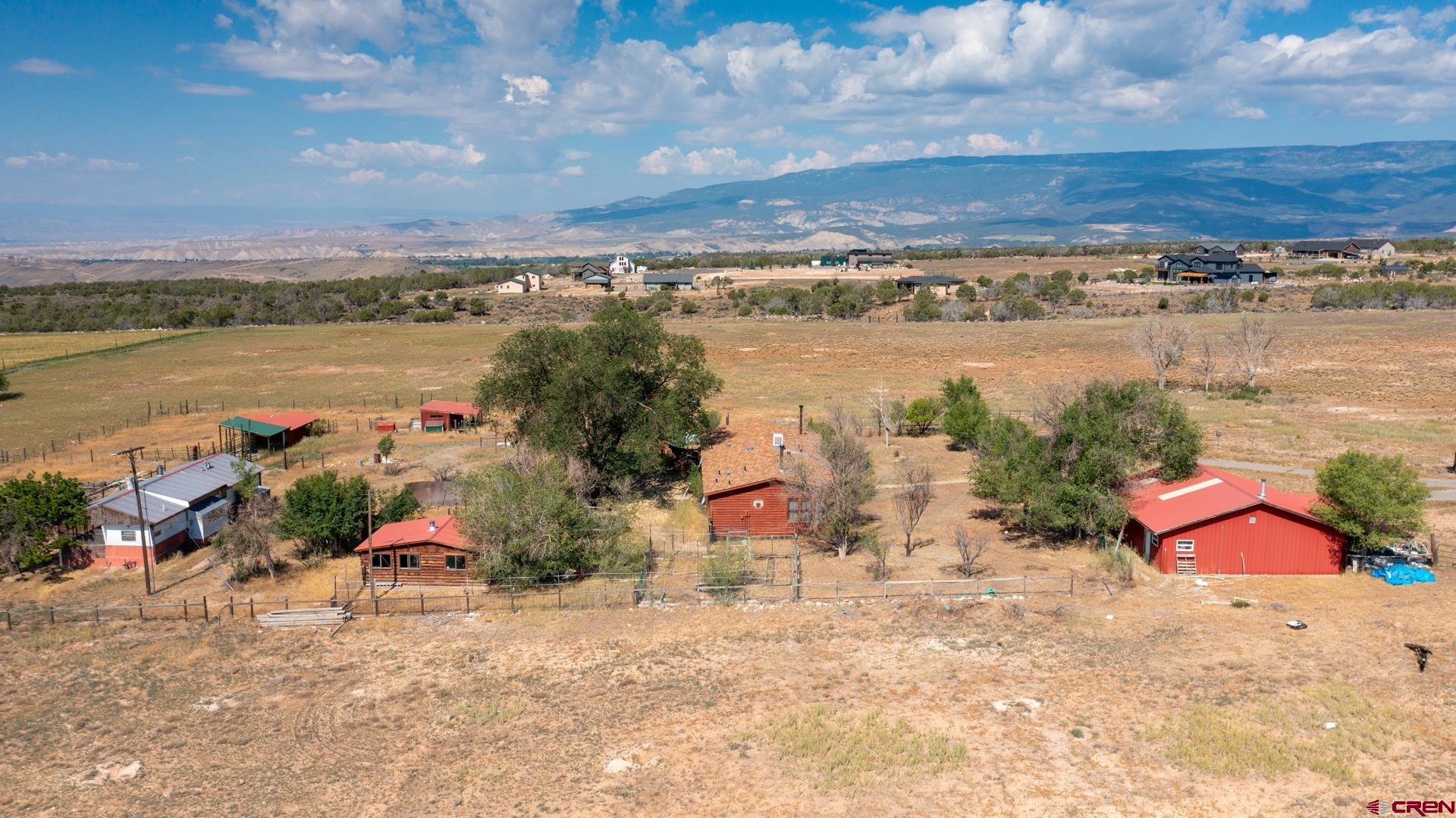25186 Cedar Mesa Road Cedaredge, CO 81413 - Photo 10 of 17 an aerial view of a houses with outdoor space