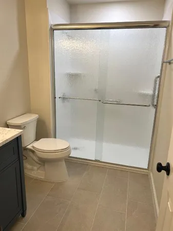 a white toilet sitting next to a bathroom sink