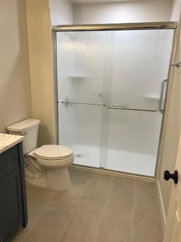 a white toilet sitting next to a bathroom sink