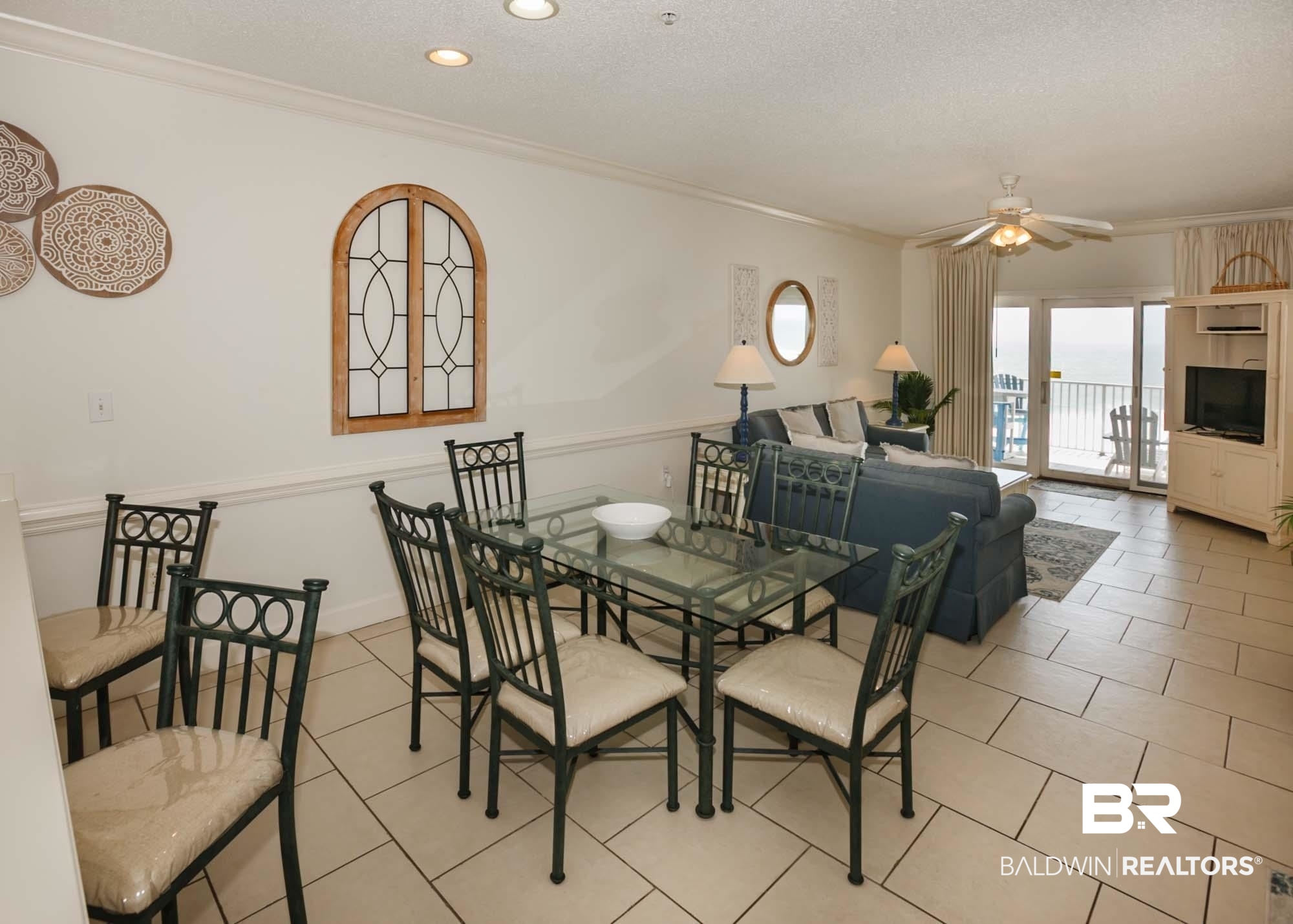 28910 Perdido Beach Boulevard, Unit 4B Orange Beach, AL 36561 - Photo 11 of 48 Dining space with light tile patterned floors, ceiling fan, and crown molding