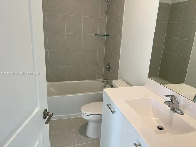 a bathroom with a shower and a window in it