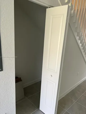 a white toilet sitting next to a bath tub and a shower