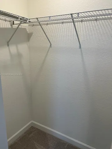 a view of a yard with wooden fence