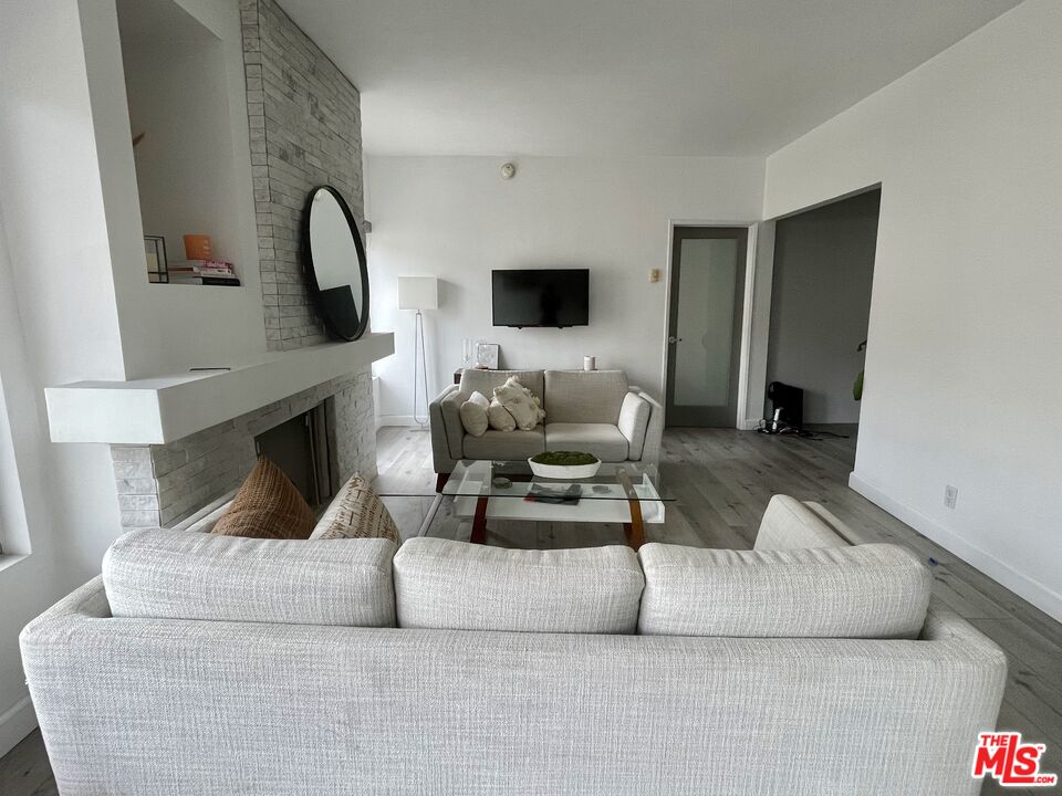 11906 Gorham Avenue, Unit 4 Los Angeles, CA 90049 - Photo 3 of 11 a living room with furniture and a fireplace