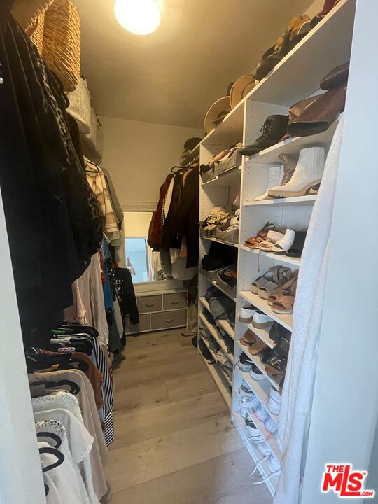 11906 Gorham Avenue, Unit 4 Los Angeles, CA 90049 - Photo 9 of 11 a view of walk in closet with clothes and shoes