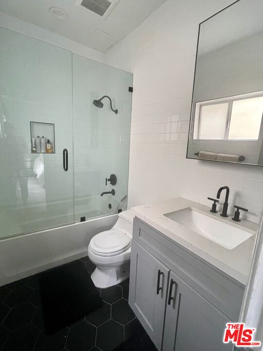 11906 Gorham Avenue, Unit 4 Los Angeles, CA 90049 - Photo 10 of 11 a bathroom with a sink a toilet and shower
