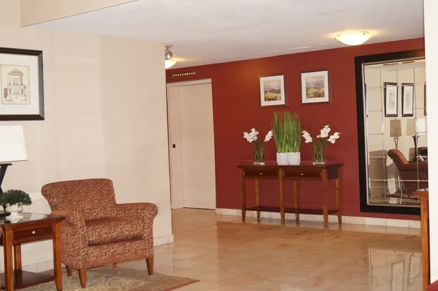 a dining room with furniture and chandelier fan