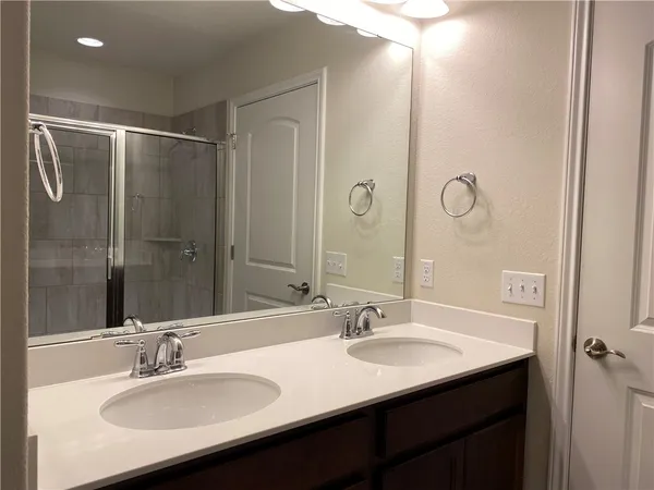a bathroom with a double vanity sink a and mirror
