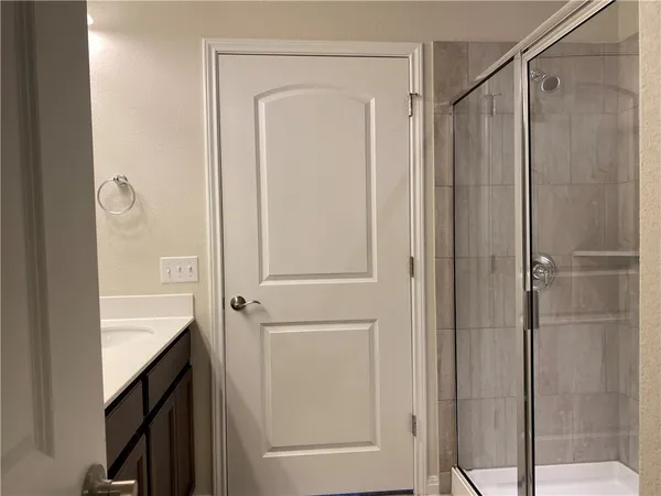 a bathroom with a shower and a sink