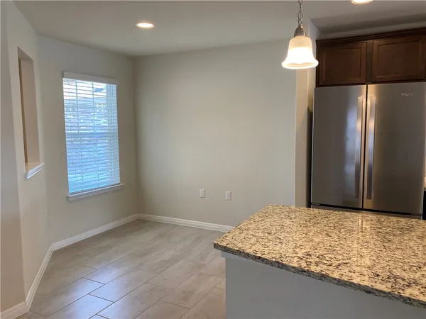a bathroom with a granite countertop sink and a shower