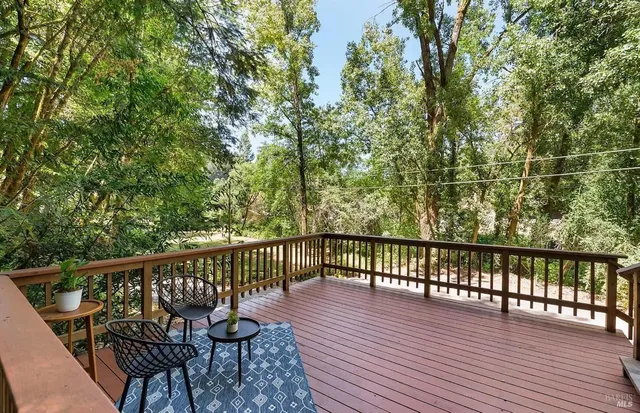 a view of balcony with wooden floor and seating
