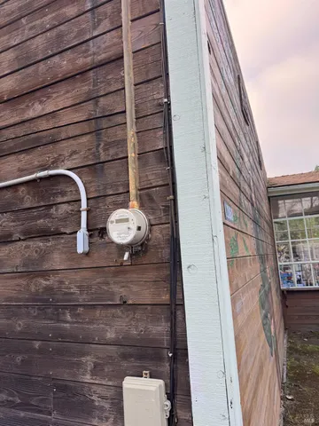 a view of a patio with table and chairs and floor to ceiling window